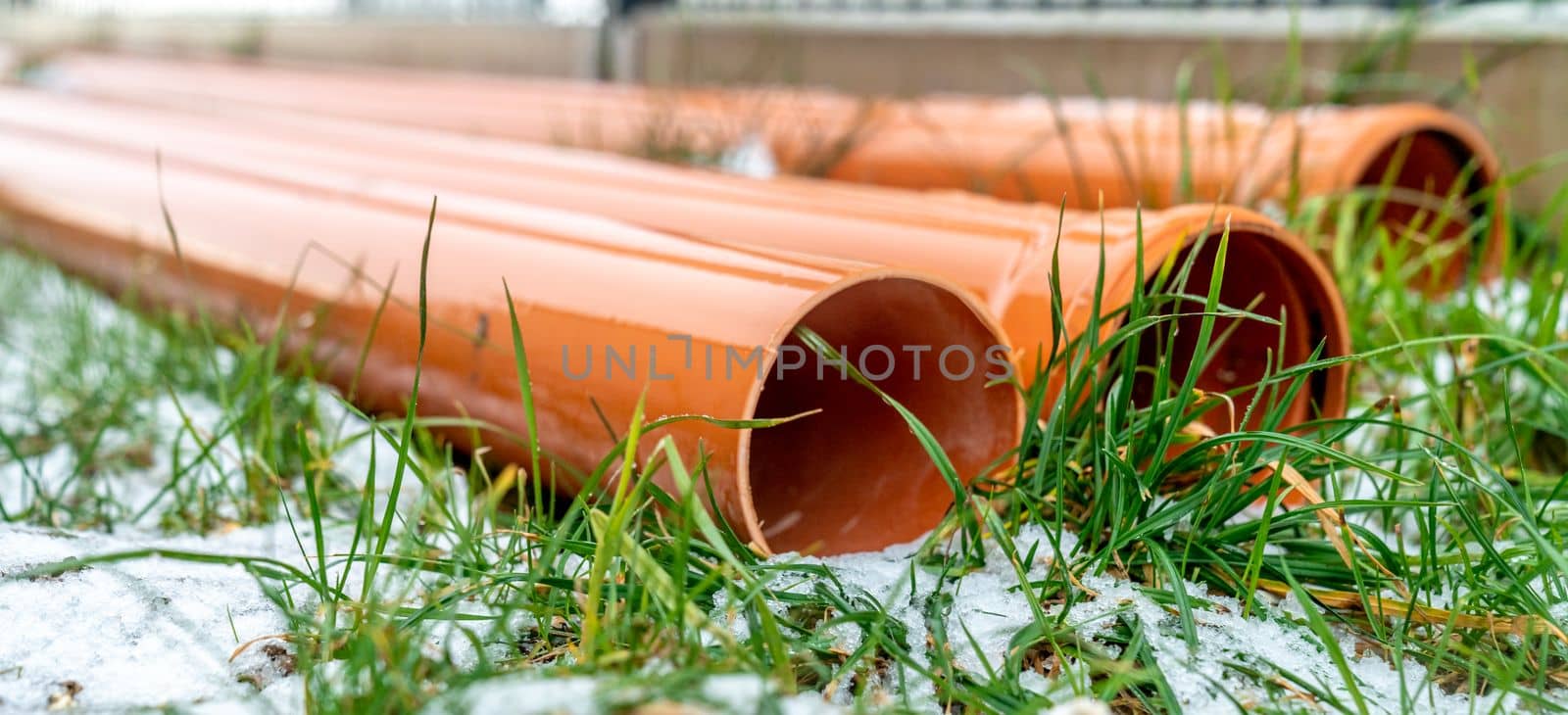 red plastic pipe for waste water in the construction site by Edophoto