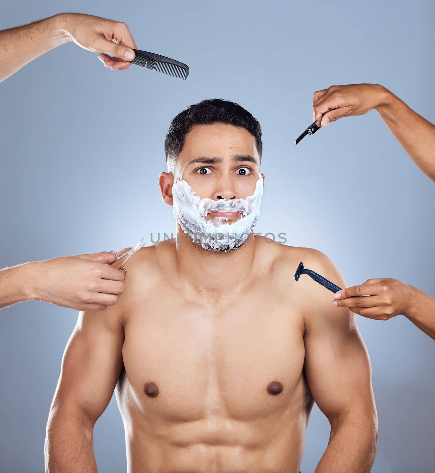 Too many options so little time. a young man unable to decide between razors against a studio background