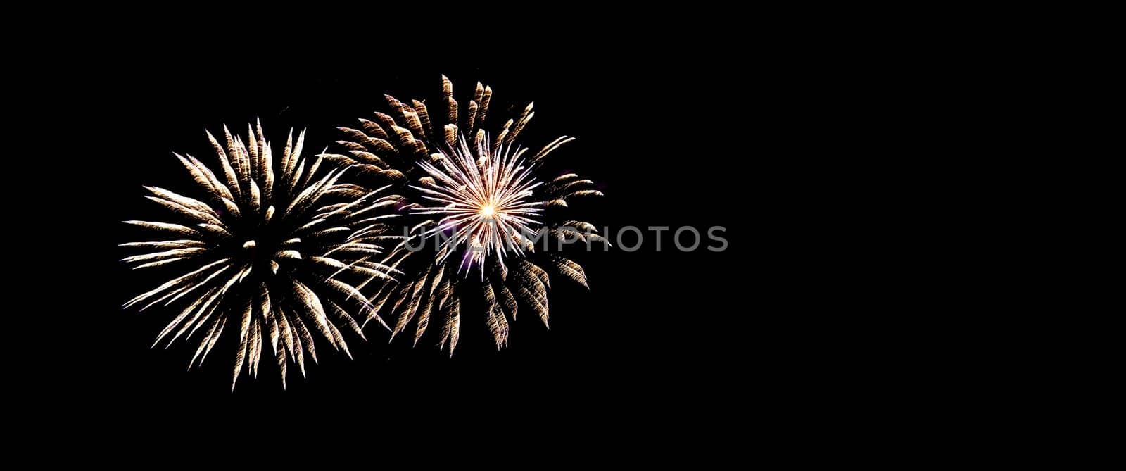 Two big fireworks and one small fireworks in the night sky.Banner,copyspace.