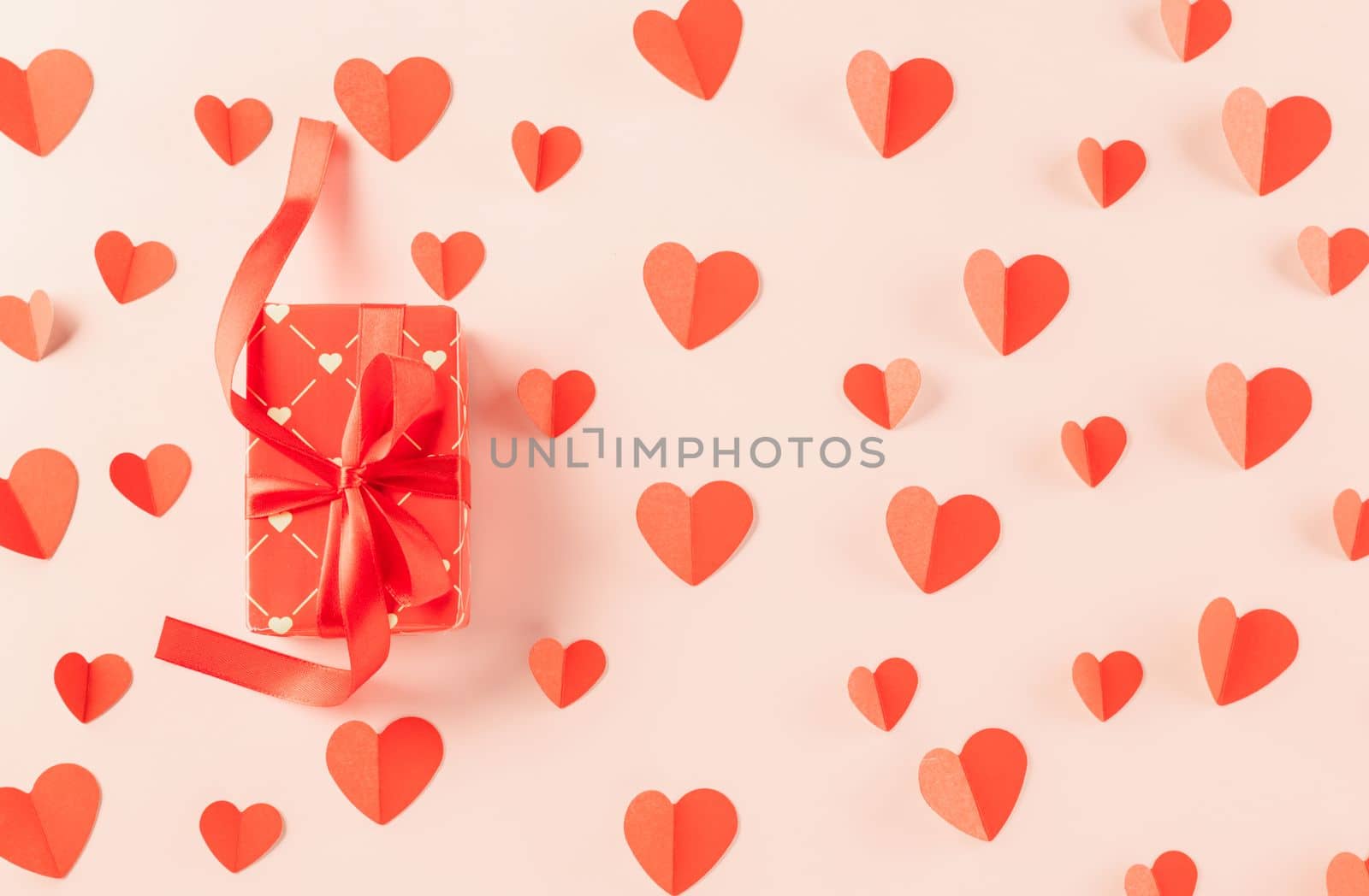 Happy Valentine Day Background. Flat lay beautiful paper hearts and gift box on pastel pink background surprise your loved with copy space, mother's day, concept banner holiday, Valentines day concept