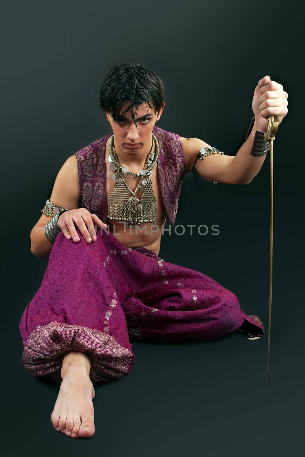 Young serious man with saber look at you