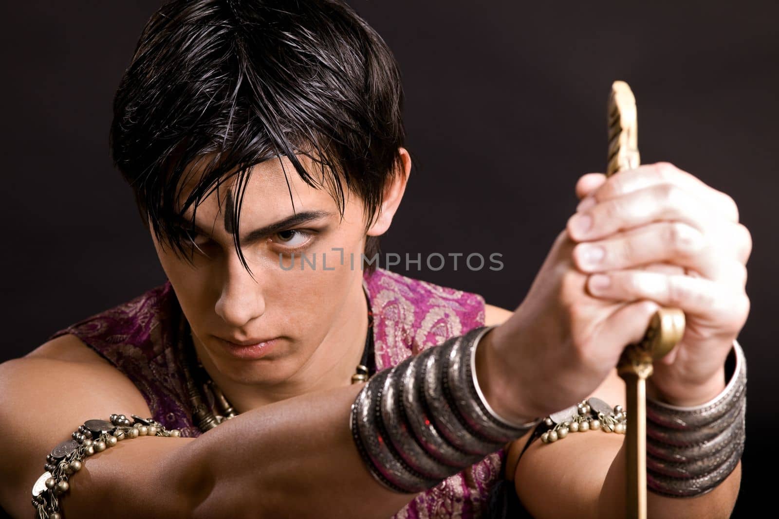 Portrait of young serious man with saber