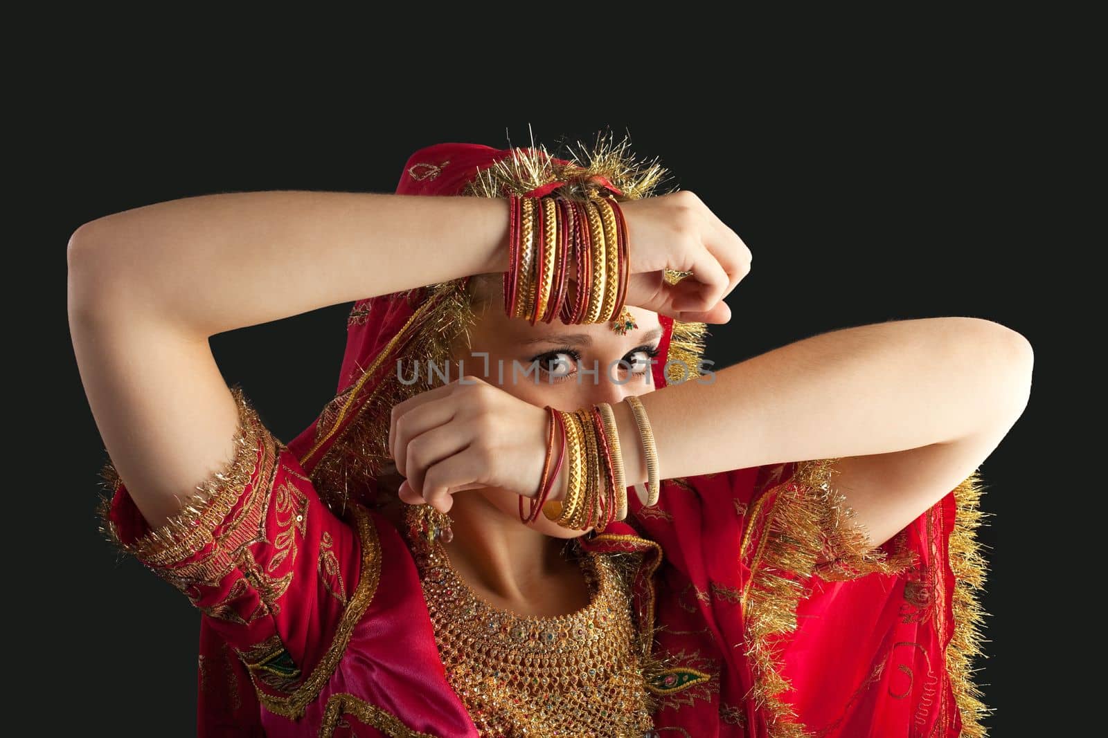 young beauty girl posing in red oriental indian costume closeup portrait