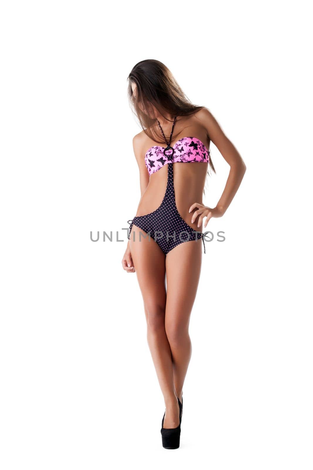 Lovely model with long hair posing in swimsuit, isolated on white