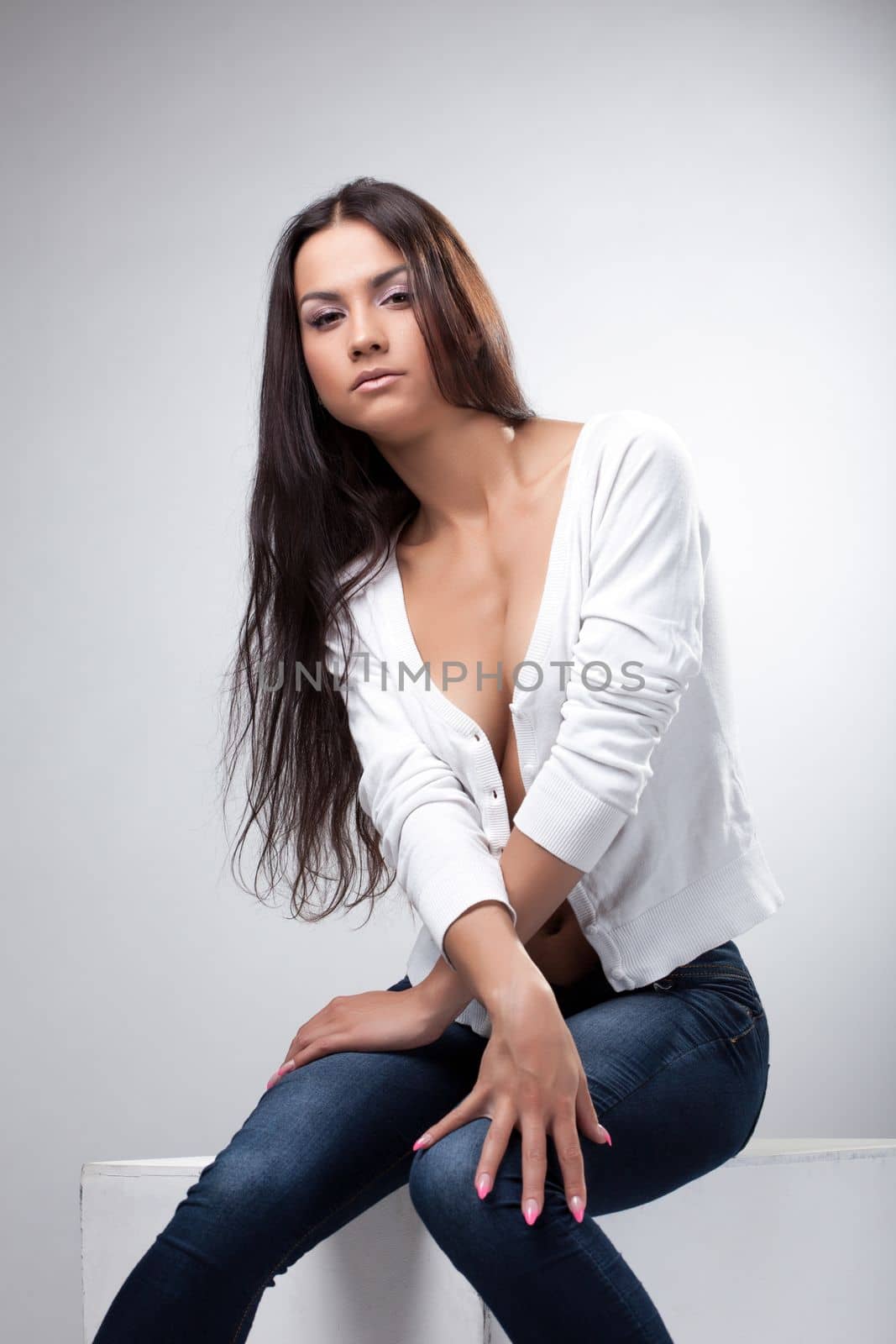 Image of beautiful young woman with long hair, on gray background