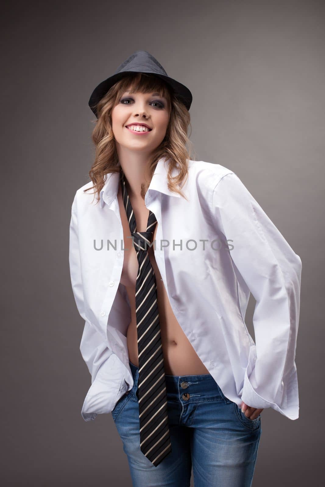 Sexy young girl show striptease topless in white shirt and black hat