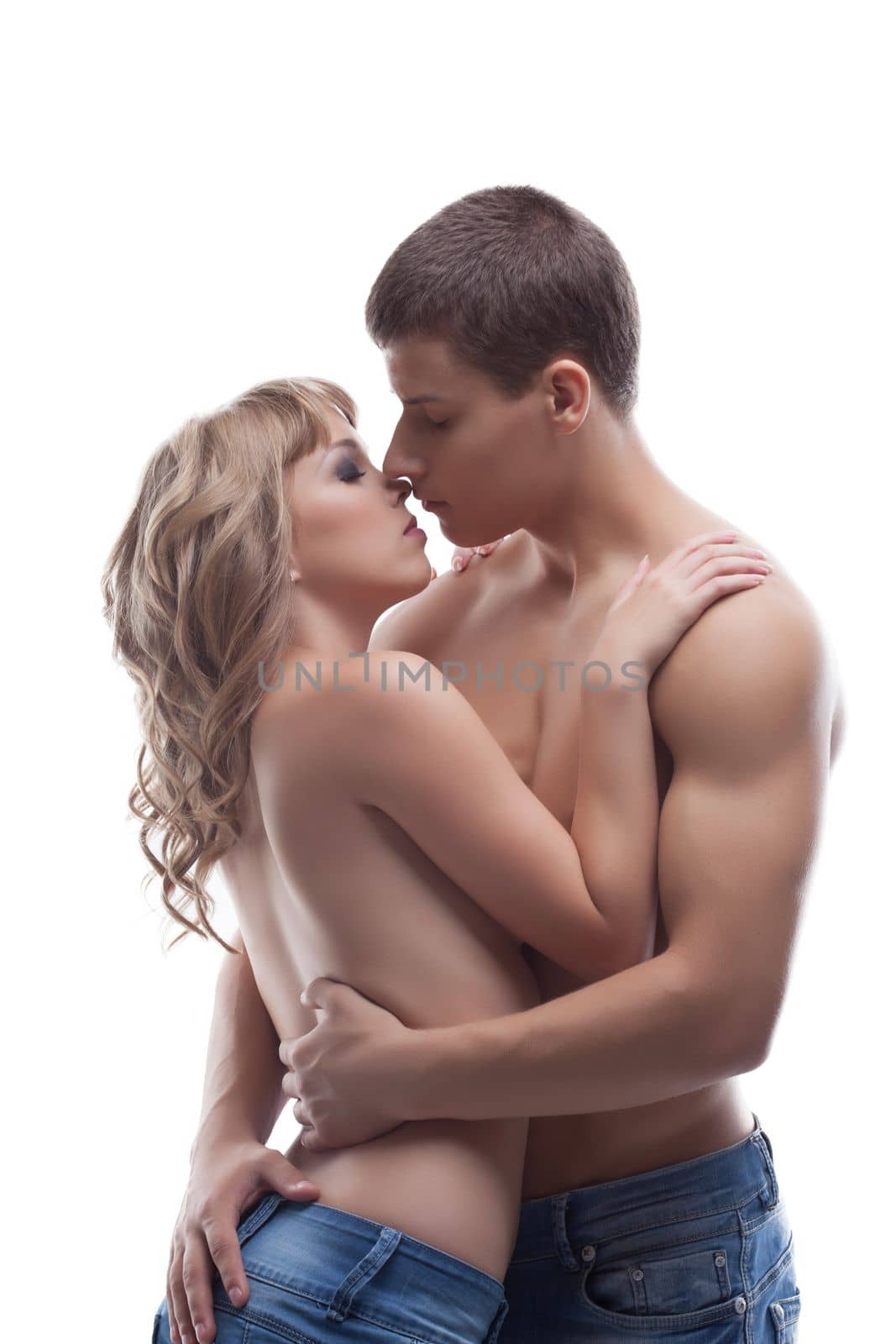 young strong man and sexy girl kiss topless in jeans isolated
