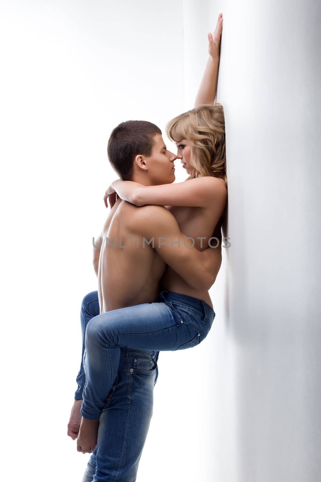 Young passionate couple of man and woman posing in studio