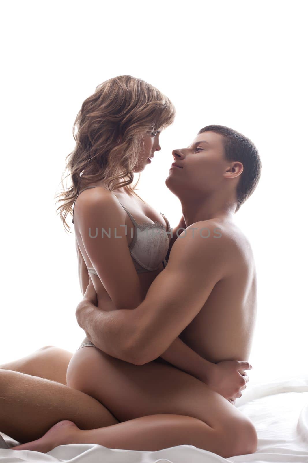 Couple playful lovers sit in bed - sexual games by rivertime