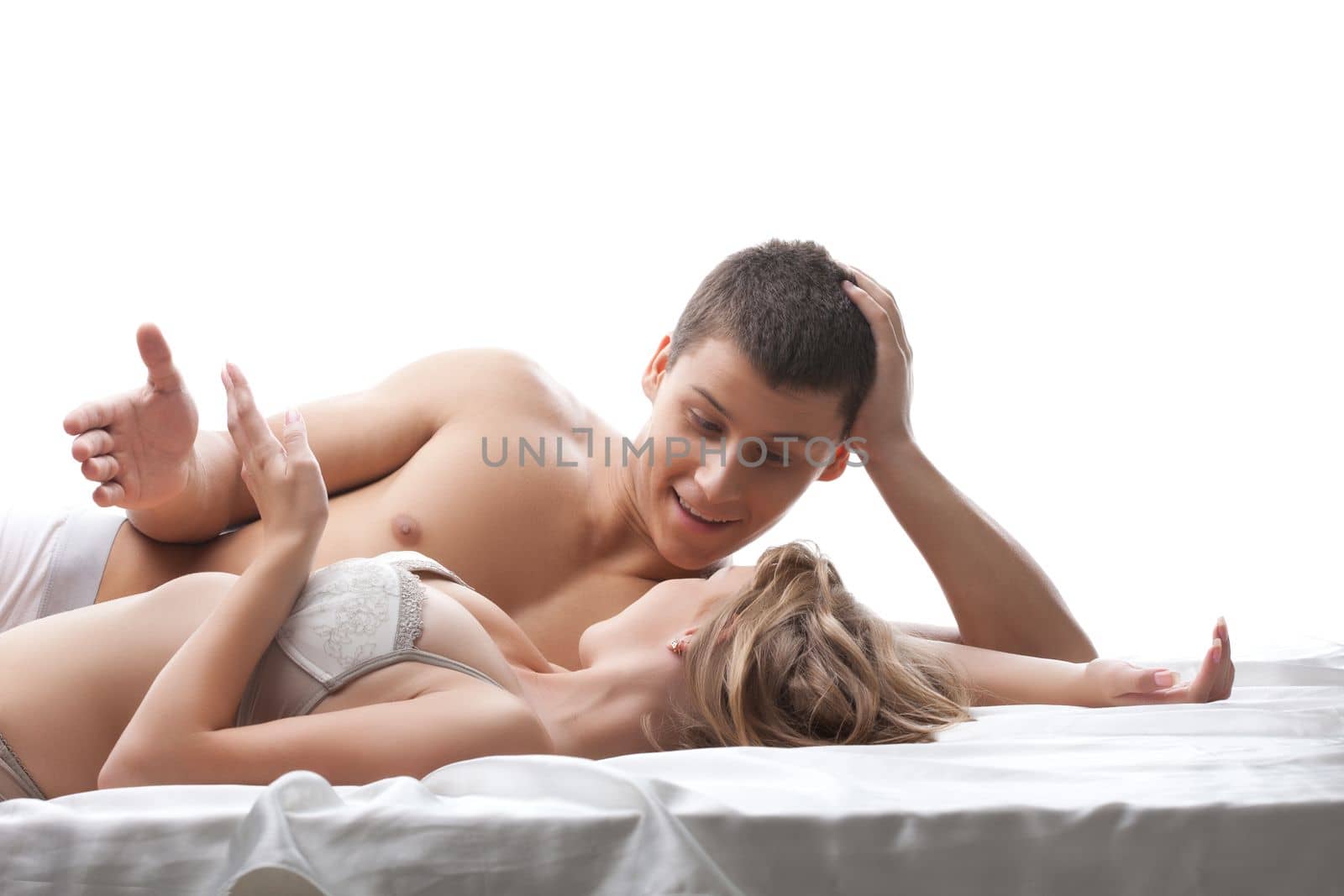 Couple lovers talk and smile in bed by rivertime