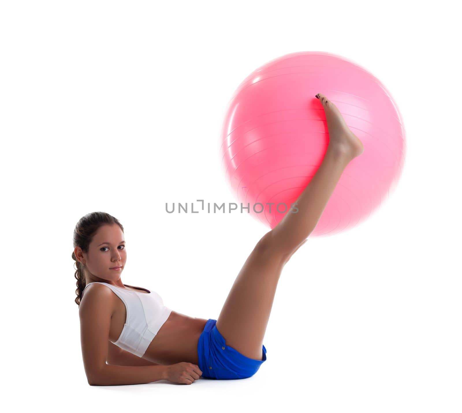 woman lay and take fitness ball with legs isolated