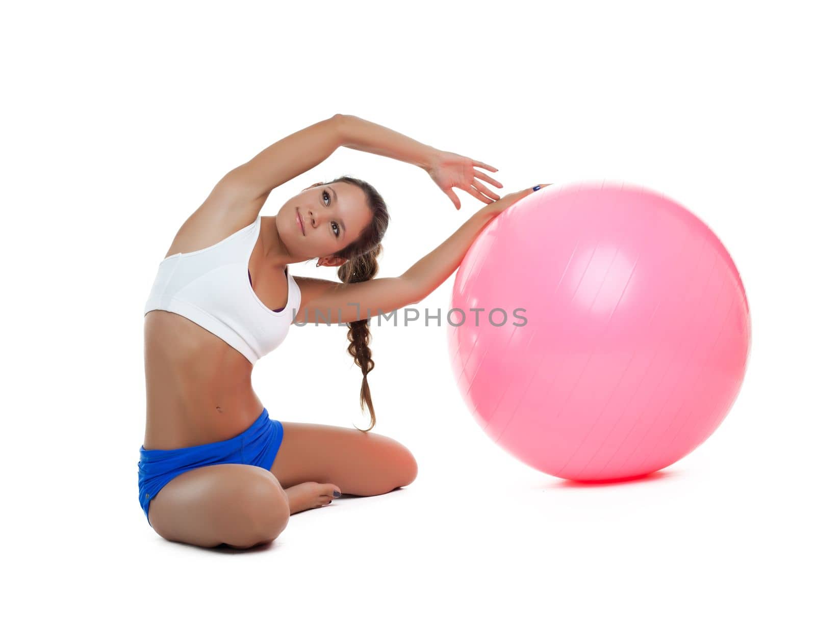 young woman show stretch with fitness ball isolated