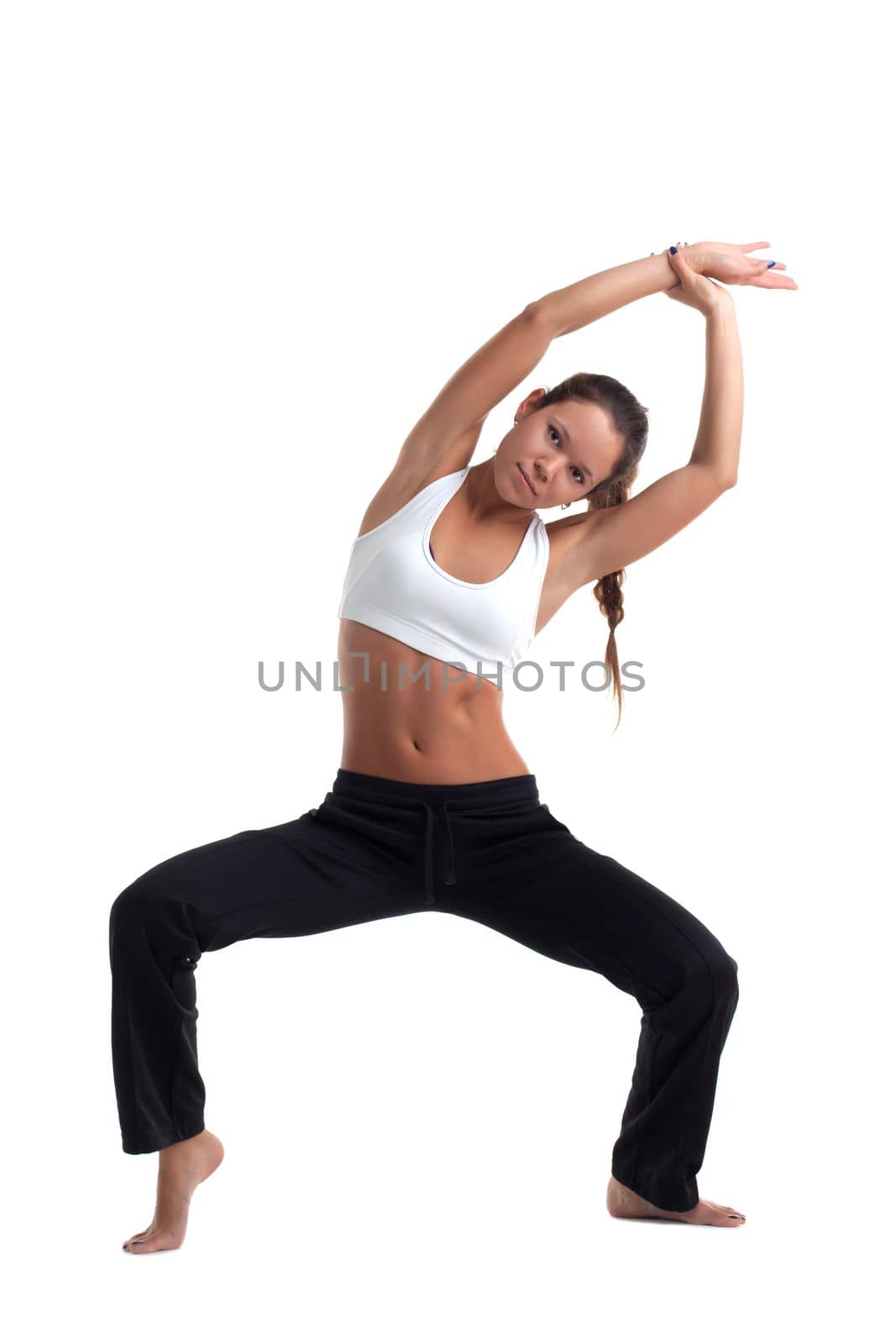 Young woman with perfect body posing in fitness costume isolated