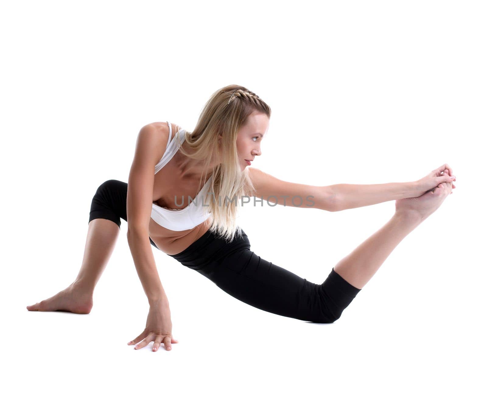 young woman in fitness costume doing split isolated