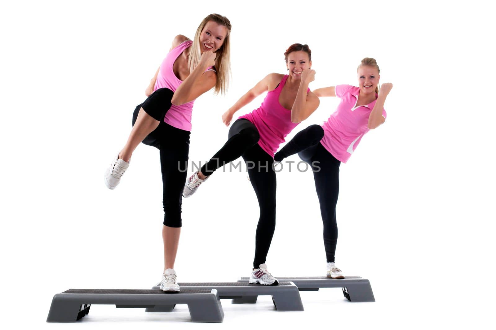 young group women training on stepper and smile isolated