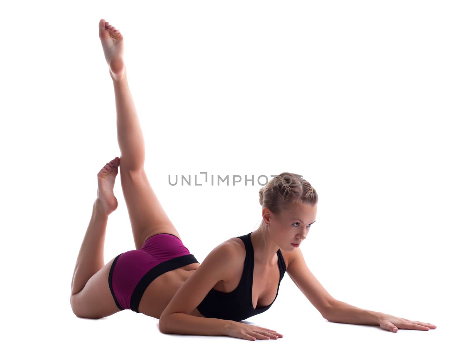 young woman in fitness costume doing split isolated