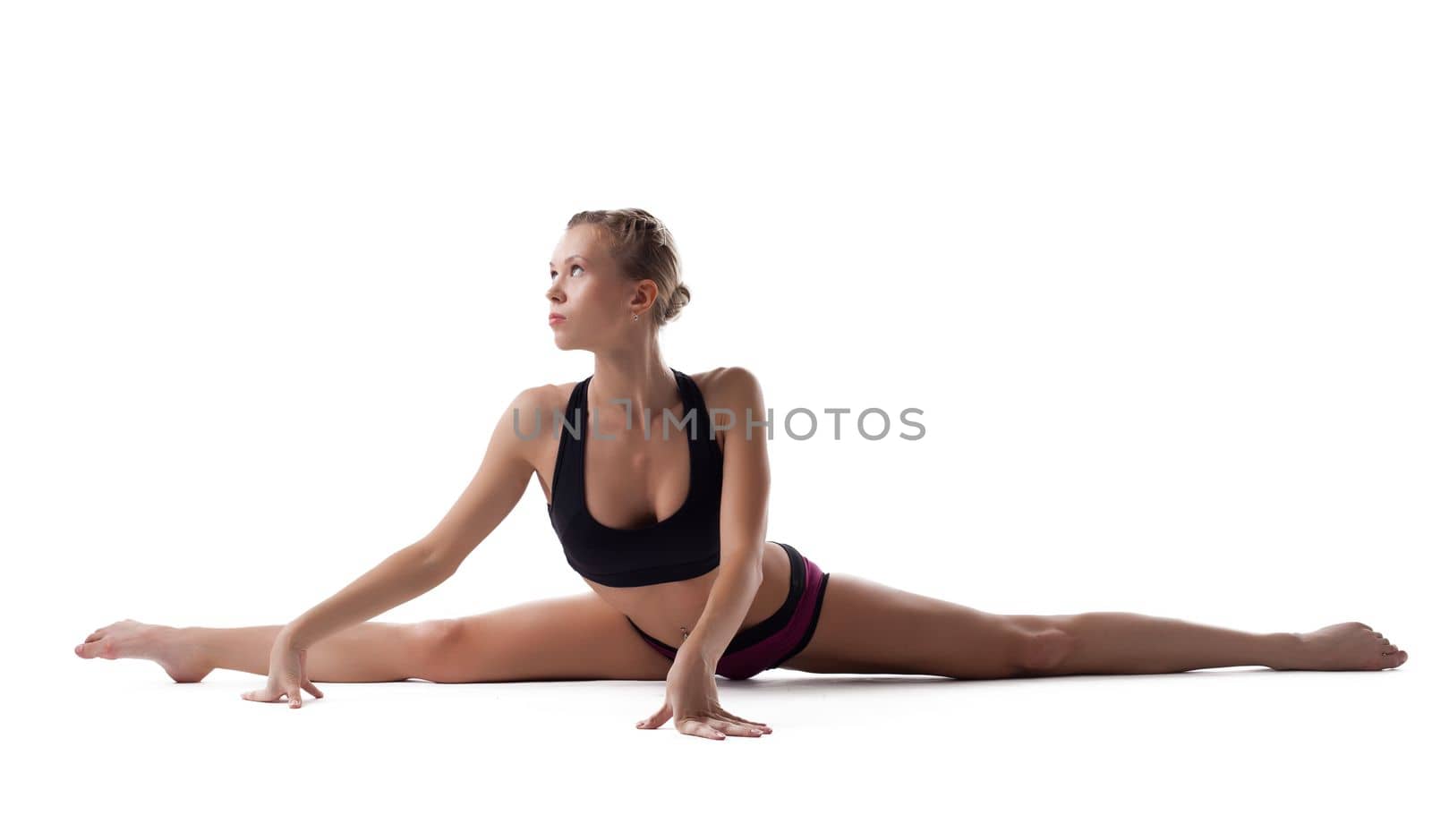 young woman in fitness costume show perfect split isolated