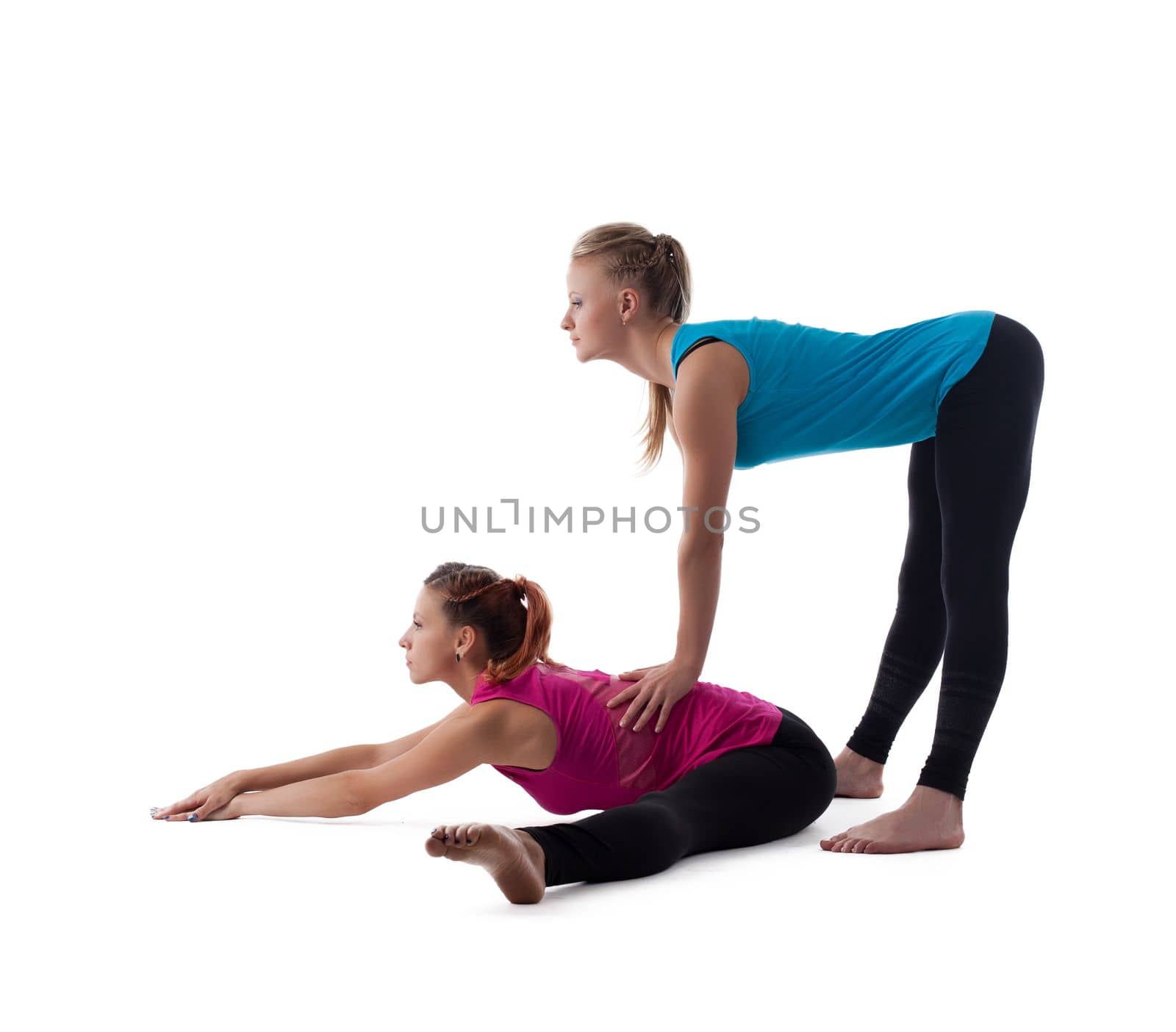 Two young woman - fitness instructor doing stretch exercise isolated