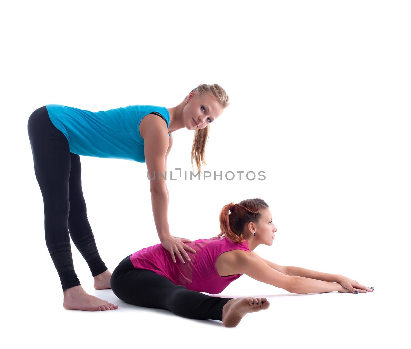 Two beauty women - fitness instructor doing stretch exercise isolated