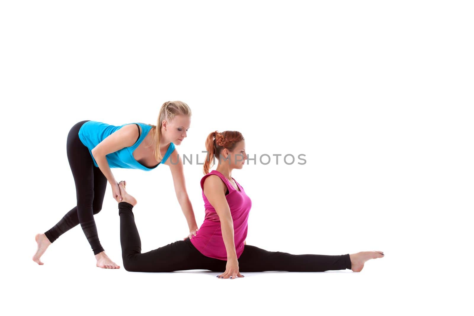 fitness instructor help young woman doing stretch exercise isolated