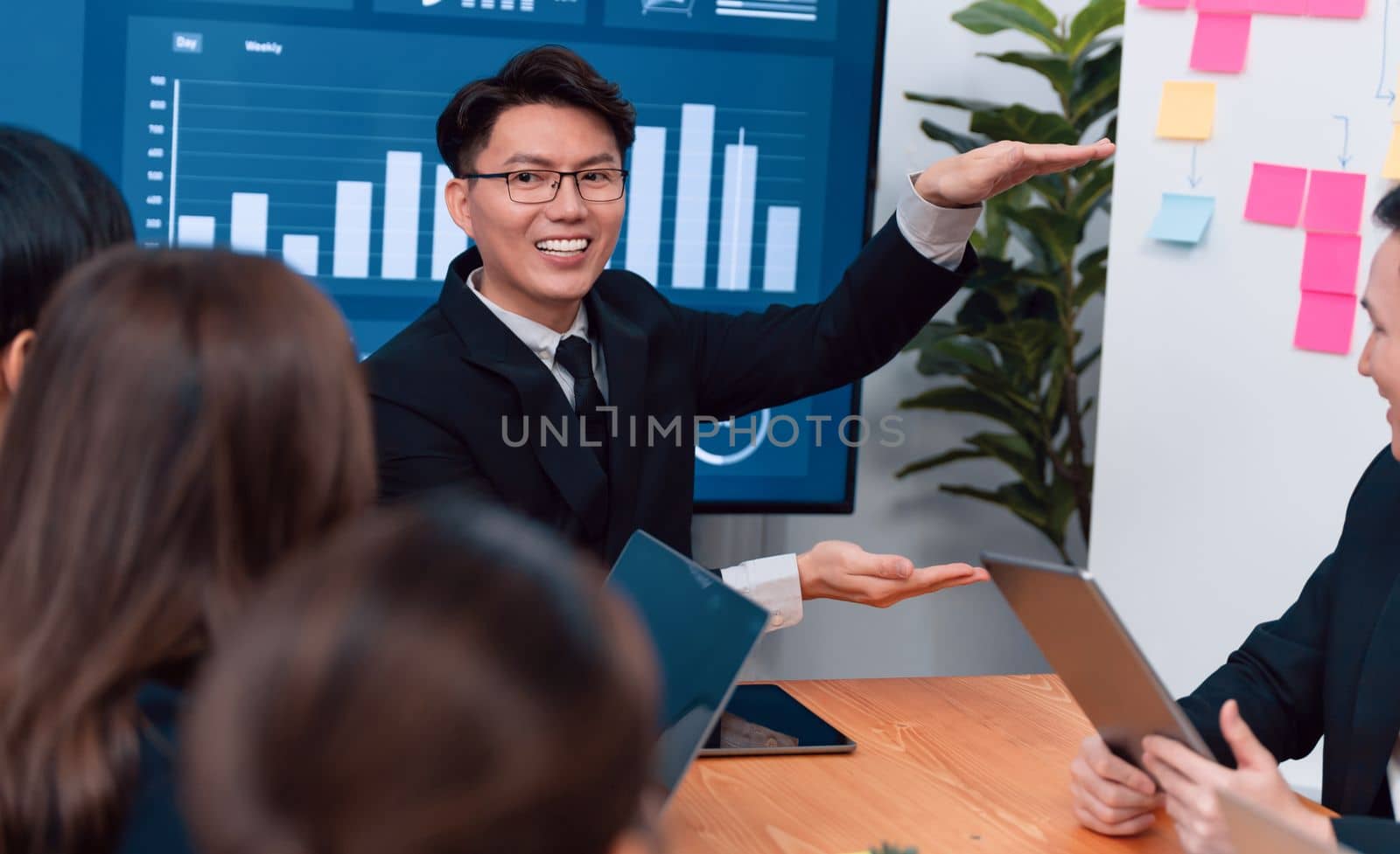 Business team of financial data analysis meeting with business intelligence, report paper and dashboard on laptop for marketing strategy. Business people working together to promote harmony in office.