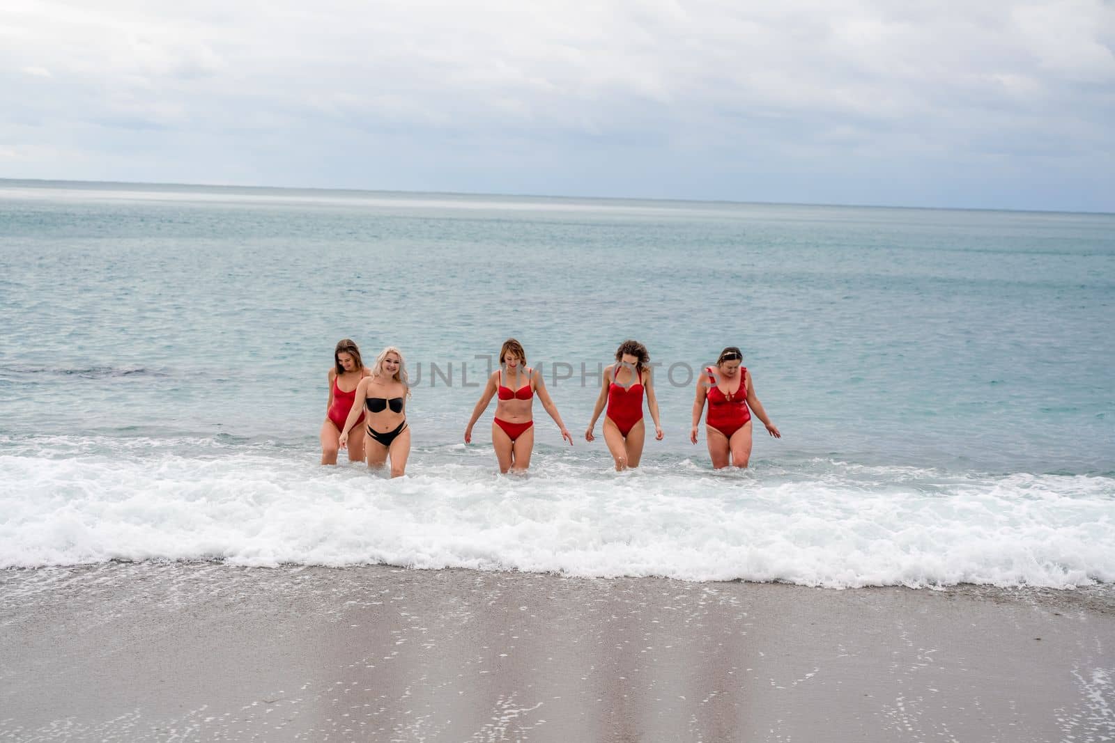 Big happy family or group of five friends is having fun against sunset beach. Beach holidays concept