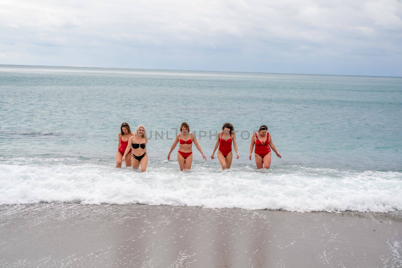 Big happy family or group of five friends is having fun against sunset beach. Beach holidays concept. by Matiunina