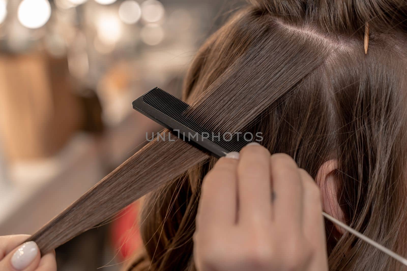 hairdresser coiffeur makes hairstyle Closeup.
