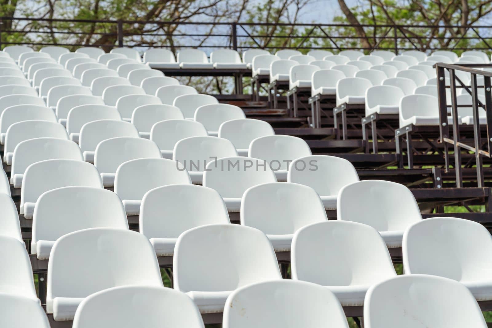 Seats of tribune on sport stadium. Concept of fans, chairs for audience, cultural environment concept. mpty seats, modern stadium