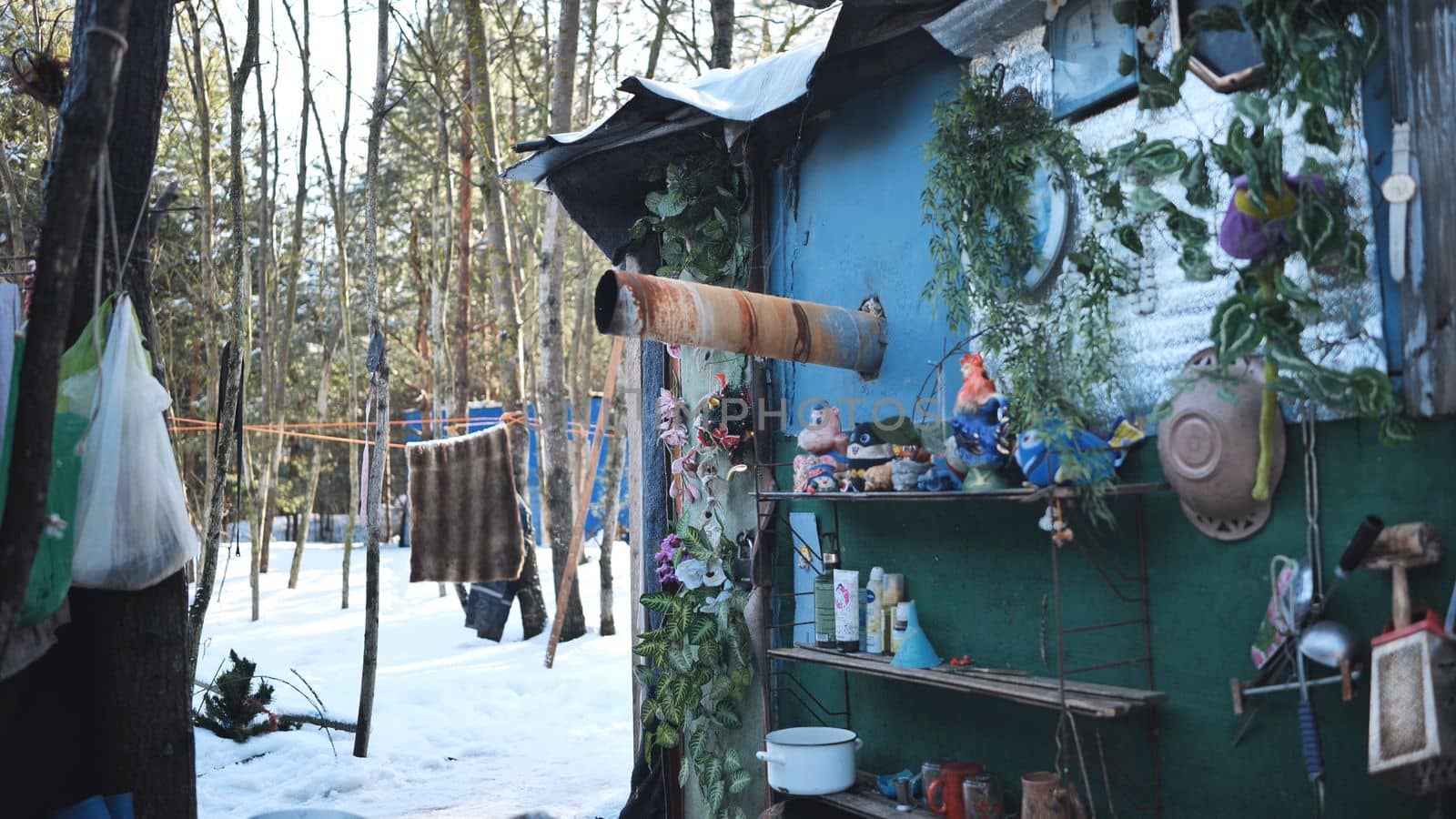 Homeless people go into their huts in the winter in the woods