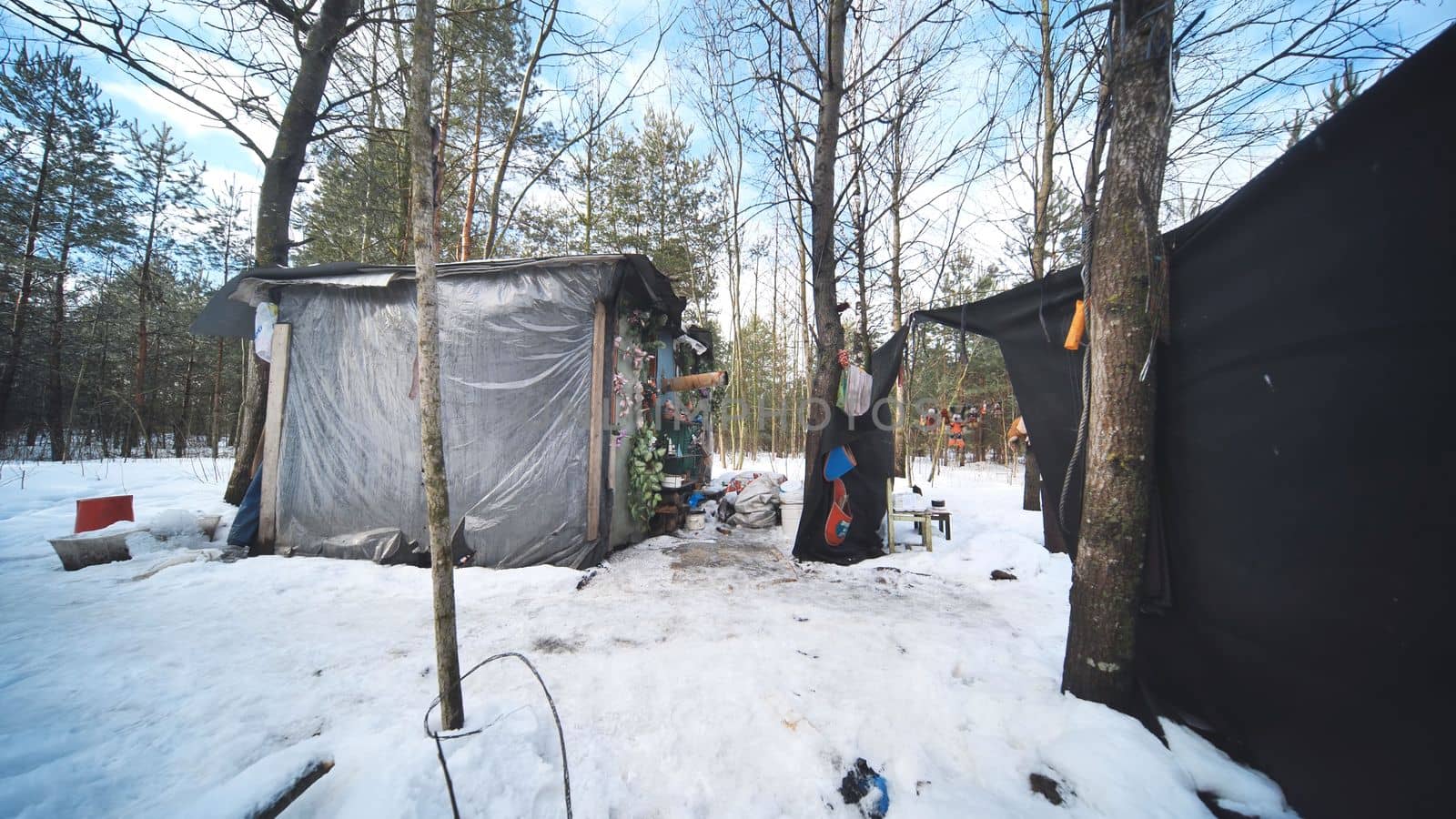 A hut of homeless people in the woods in winter