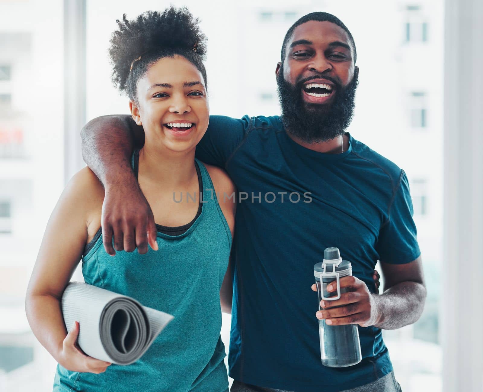 Portrait, yoga and a couple of friends in a gym for fitness while laughing at a joke or being funny together. Happy, excited and joy with yogi black people joking indoor during a wellness workout by YuriArcurs
