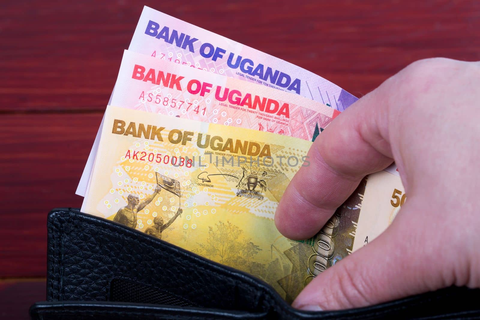 Ugandan money in the black wallet by johan10