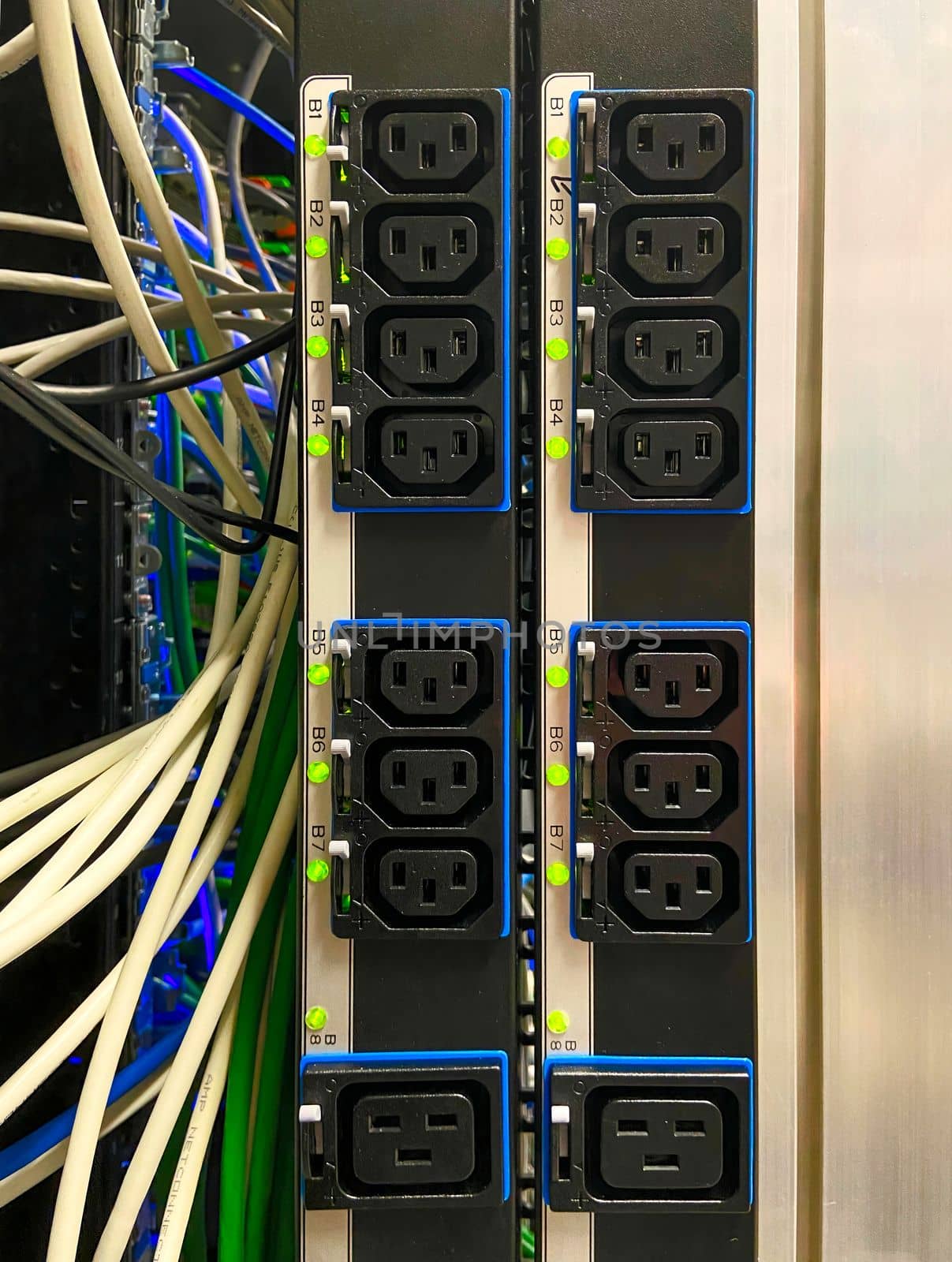 Power sockets on power bar mounted on side of data equipment rack.