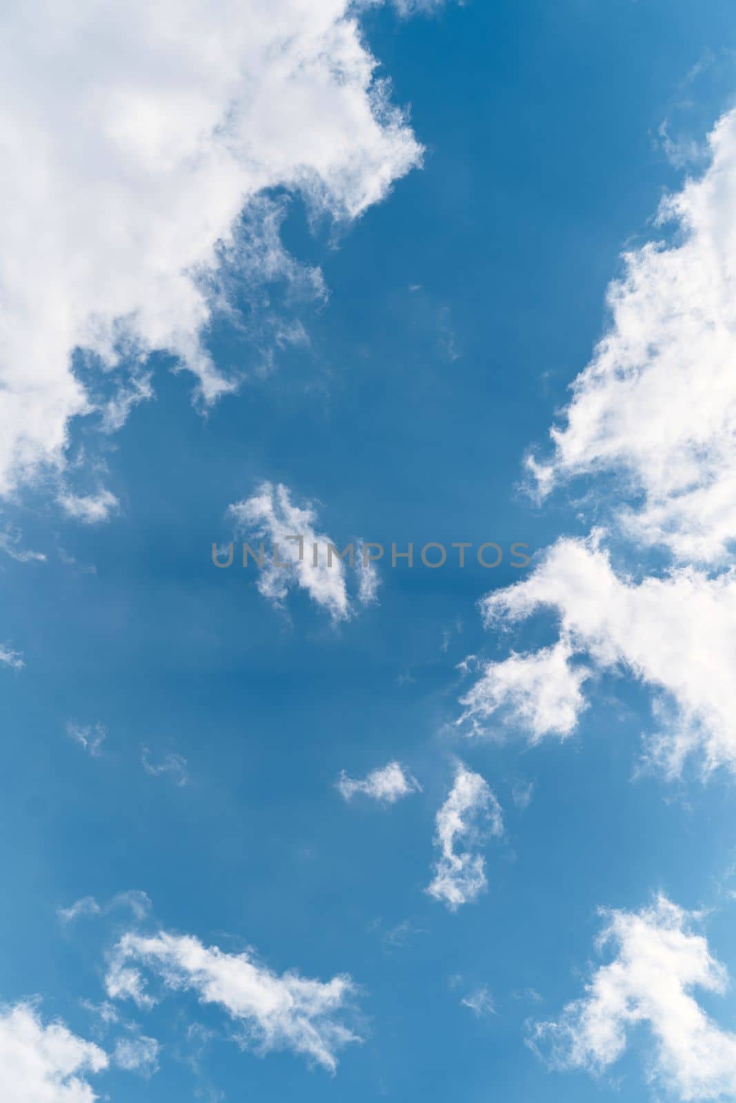 Cumulus clouds in the blue sky. Close-up by Nadtochiy