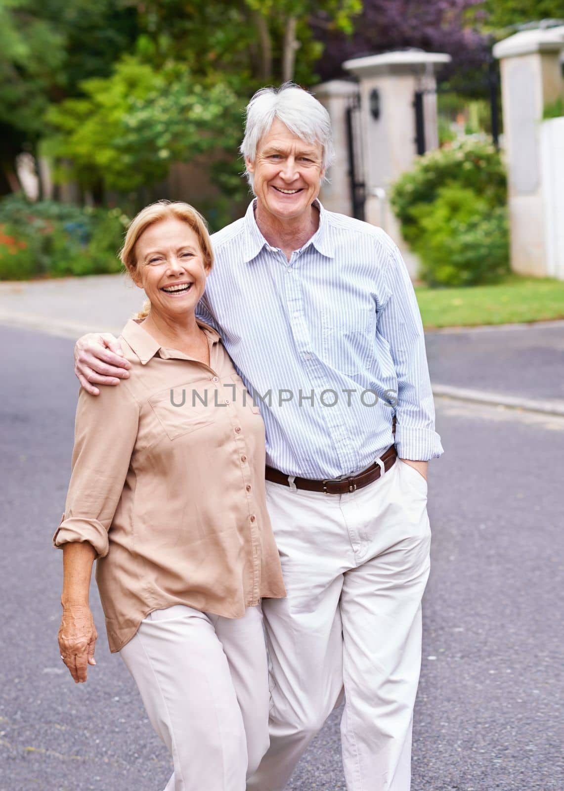 Walking down memory lane. a married couple enjoying the outdoors. by YuriArcurs