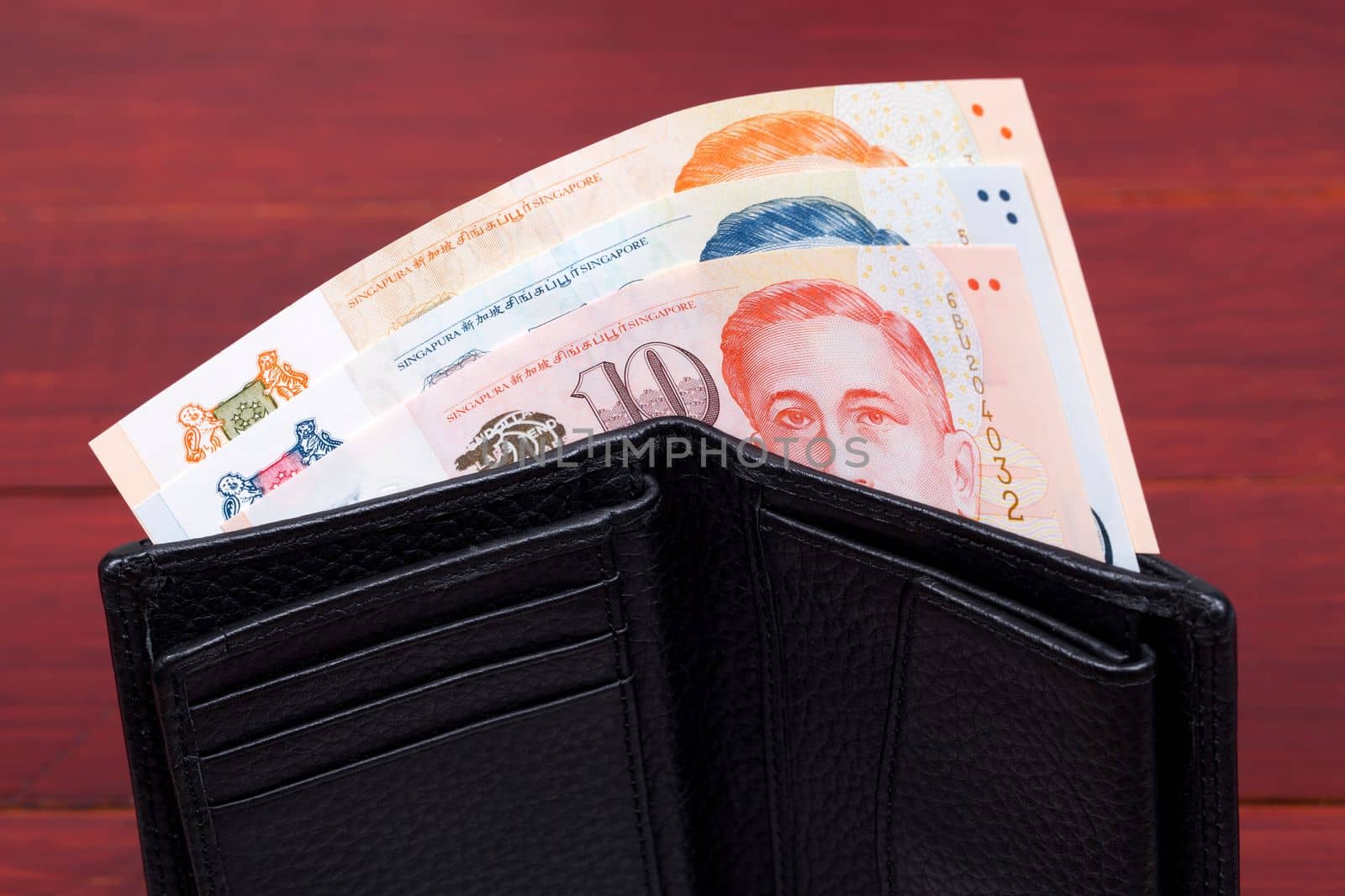 Singapore money - dollar in the black wallet by johan10