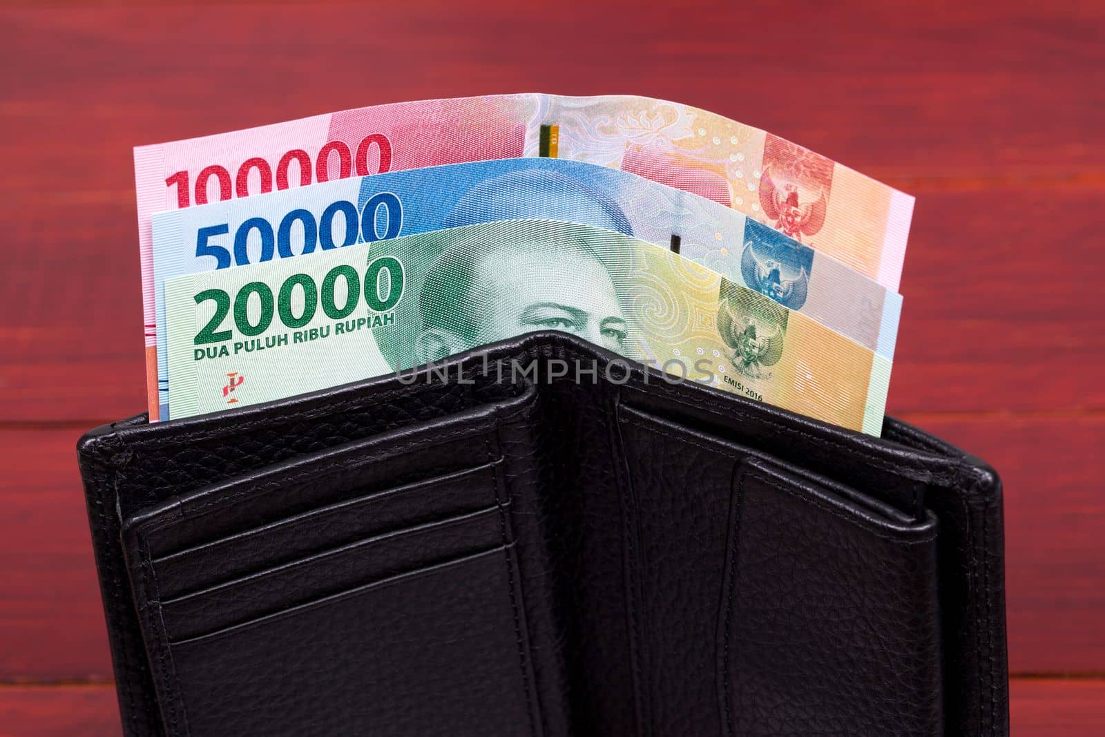 Indonesian money - rupiah in the black wallet by johan10