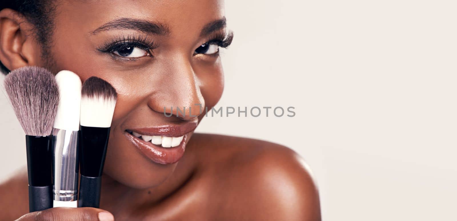 Bring your beauty to life with these. Studio shot of a beautiful young woman holding a set of makeup brushes