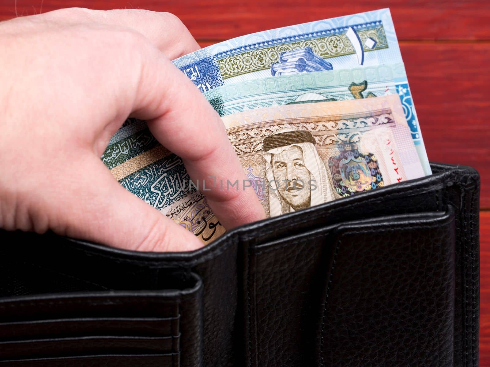 Jordanian money in the black wallet	 by johan10