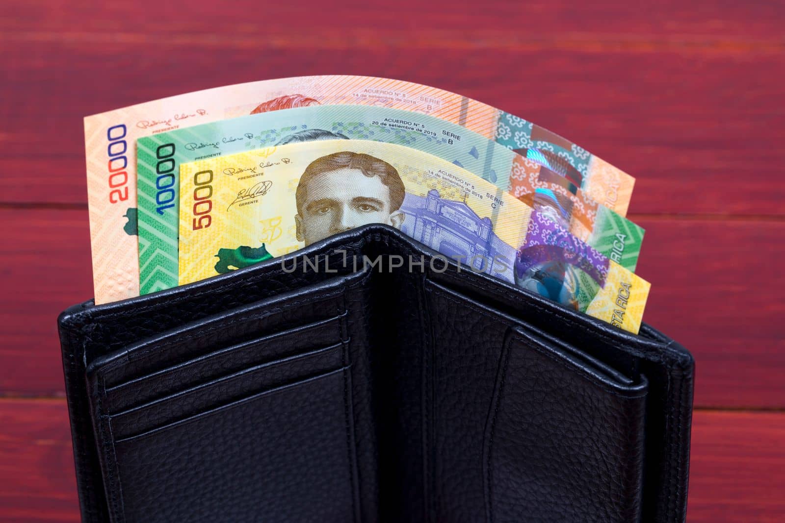 Costa Rican money in the black wallet by johan10