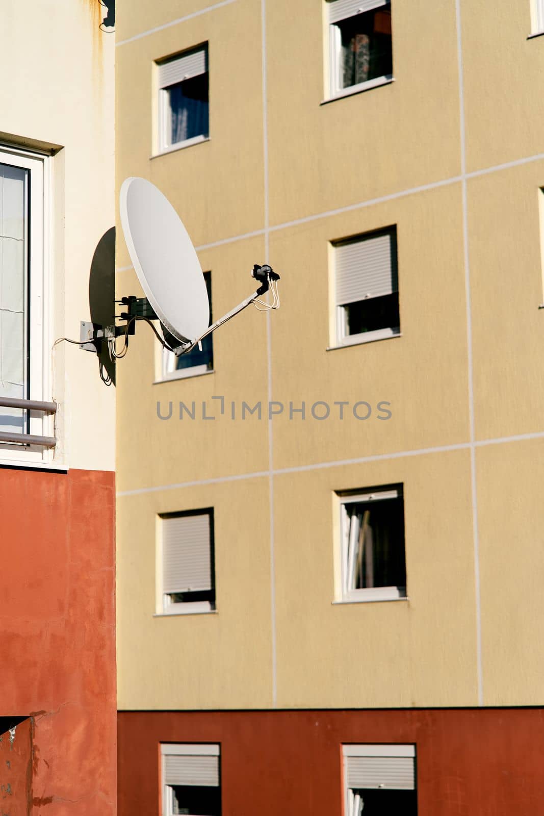 Apartment building with a satellite dish near the window. Close-up. High quality photo