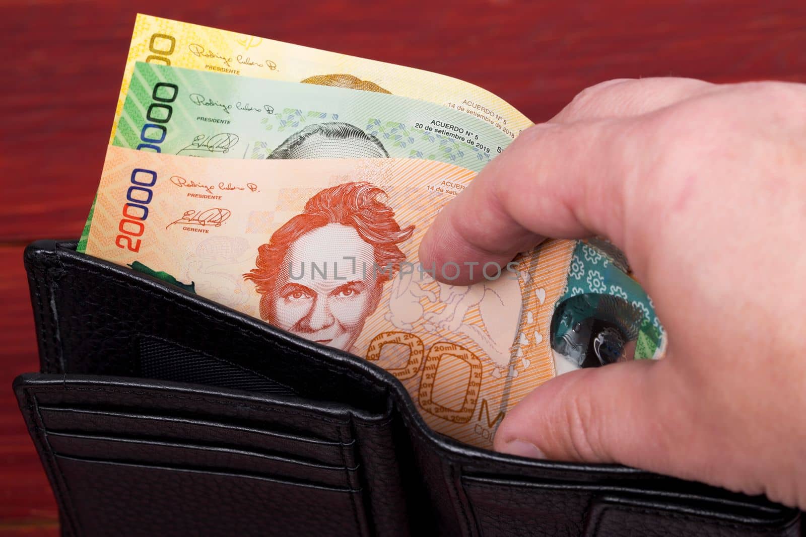 Costa Rican money in the black wallet by johan10