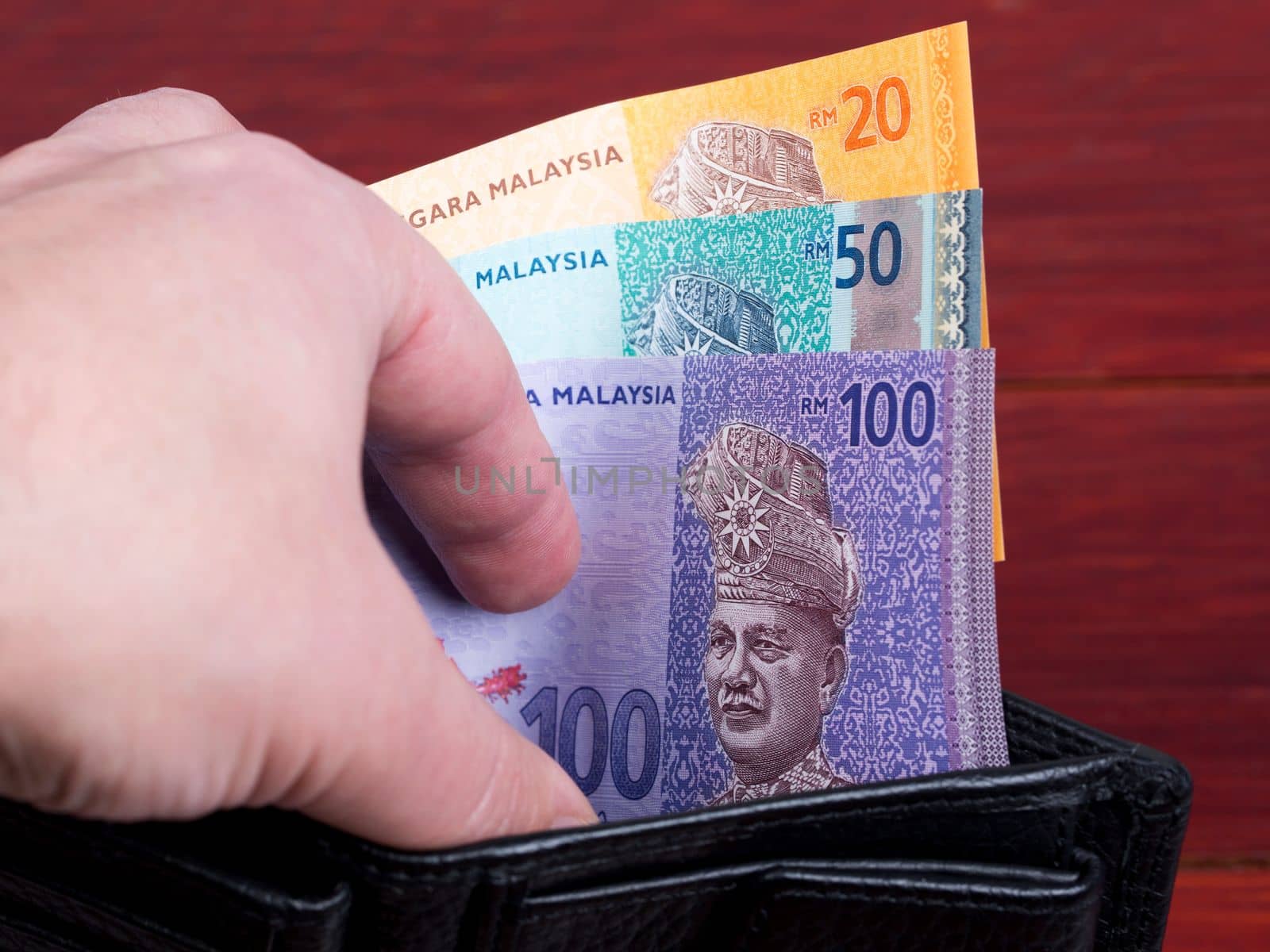 Malaysian money in the black wallet	 by johan10