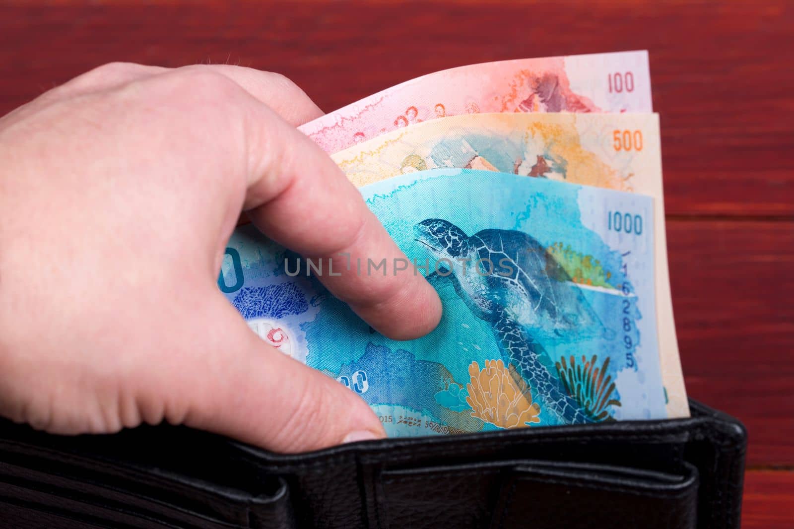 Maldivian money in the black wallet	 by johan10