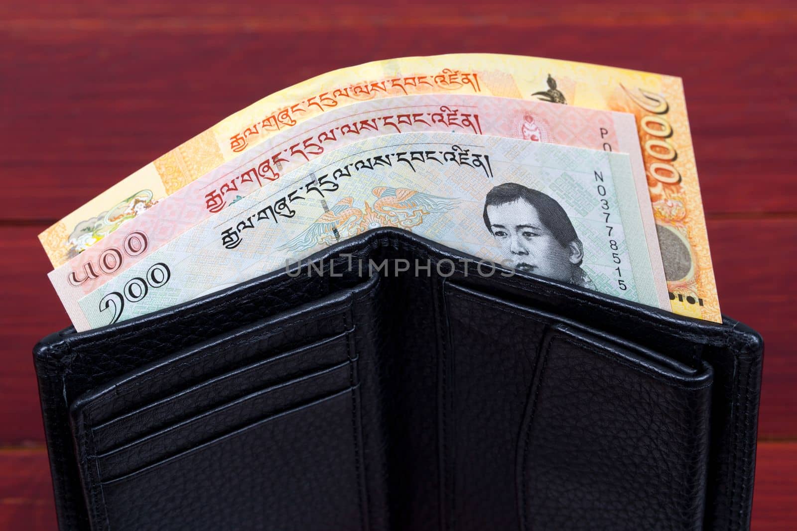 Bhutanese money in the black wallet by johan10
