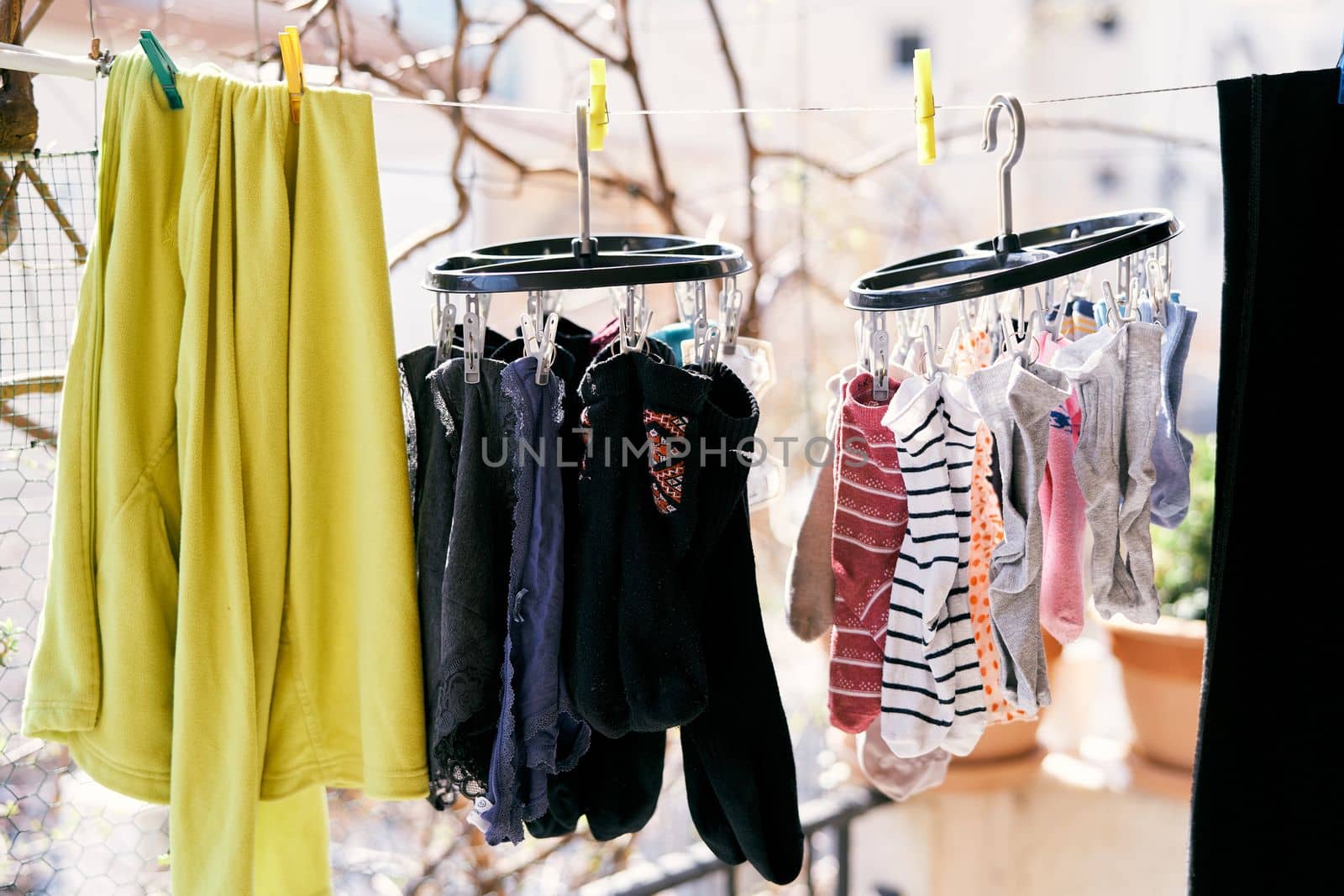 Drying clothes on a rope - jacket, socks and underpants. Close-up. High quality photo