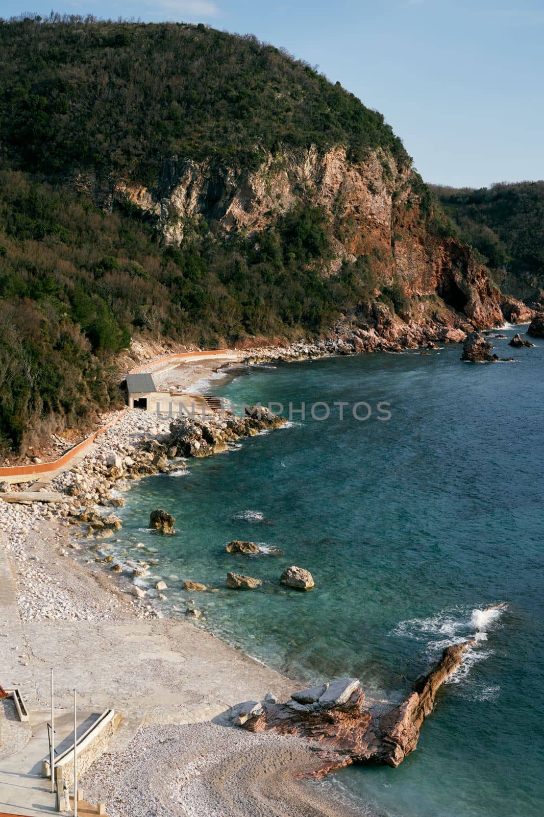 Crvena Glavica beach against the backdrop of the sea and mountains, in the Budva Riviera, Montenegro. High quality photo