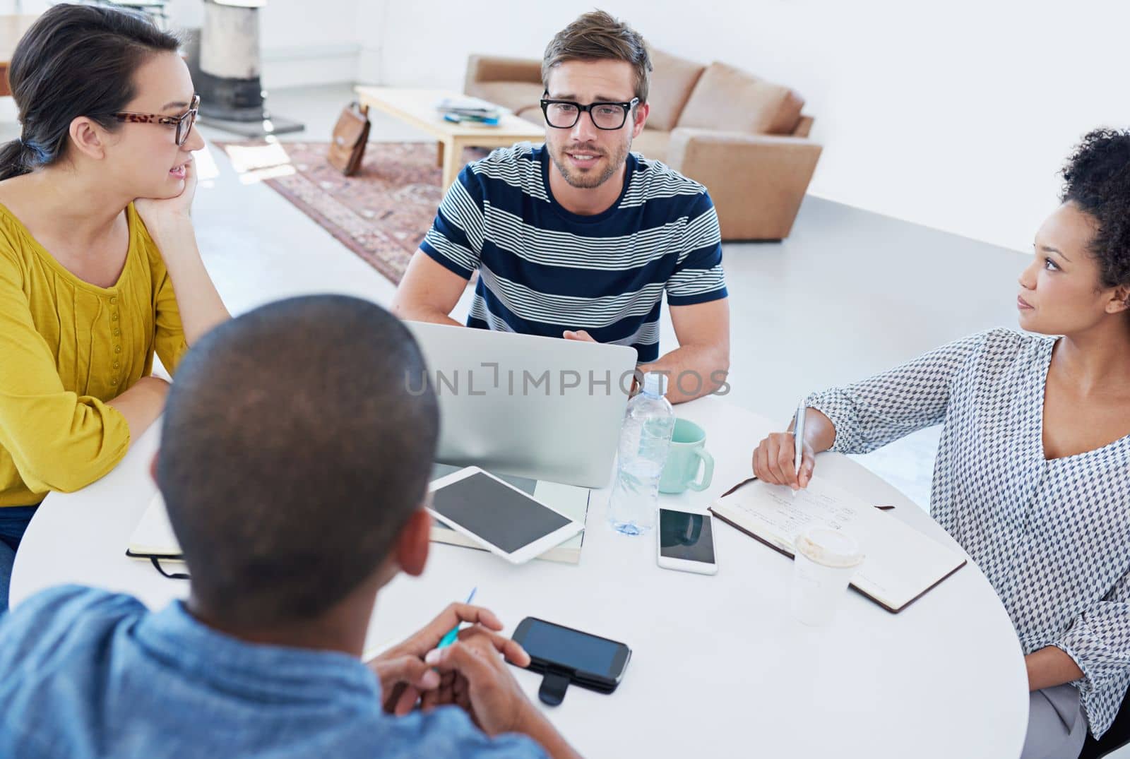 Theyre dynamic and creative. a group of designers at work in an office. by YuriArcurs