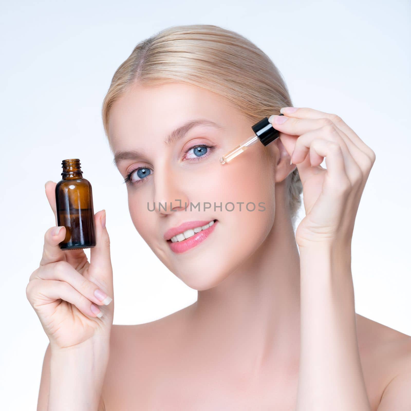 Closeup personable beautiful woman holding CBD oil in isolated background. by biancoblue